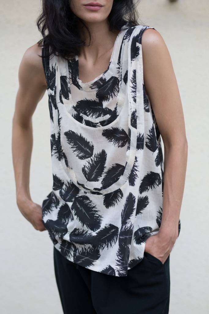 Sleeveless top with delicate, metallic feather print and scooped raw bias edge bib details.